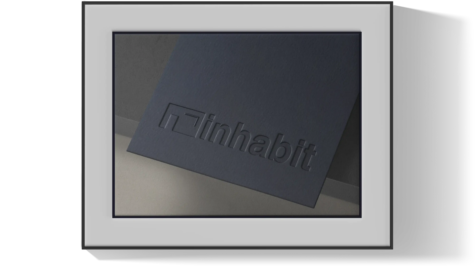Embossed Inhabit logotype on midnight card stock